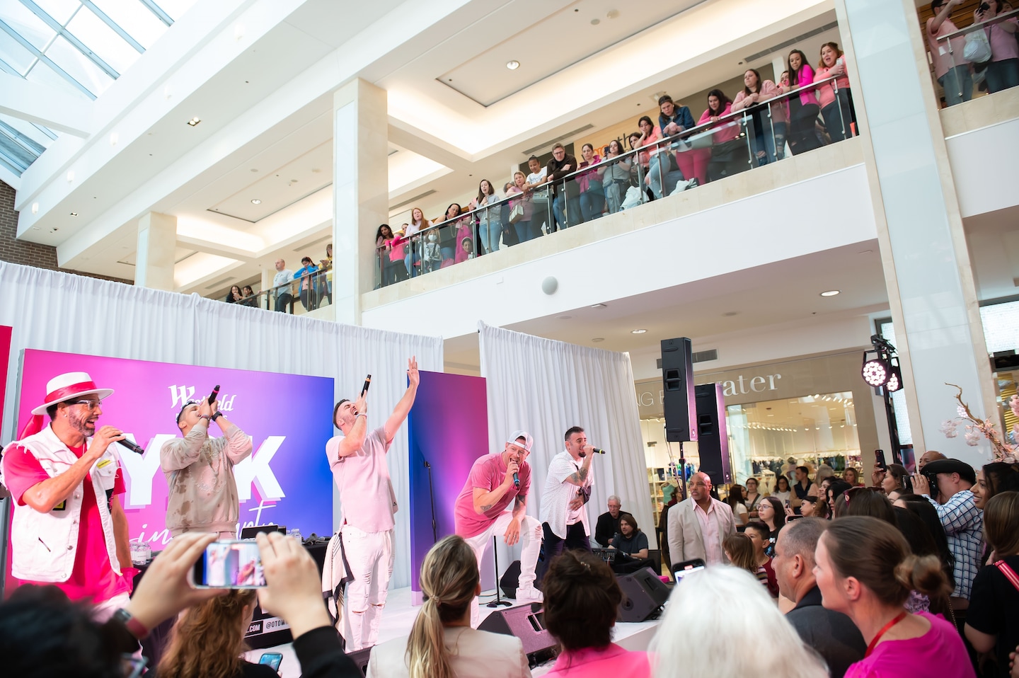 Nostalgia and Chaos: A '90s Boy Band Mall Concert in 2023.