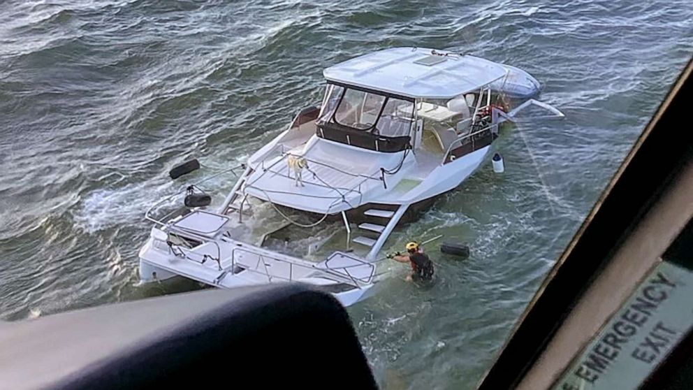 Coast Guard rescues 2 people and dog from sinking boat off Georgia coast.