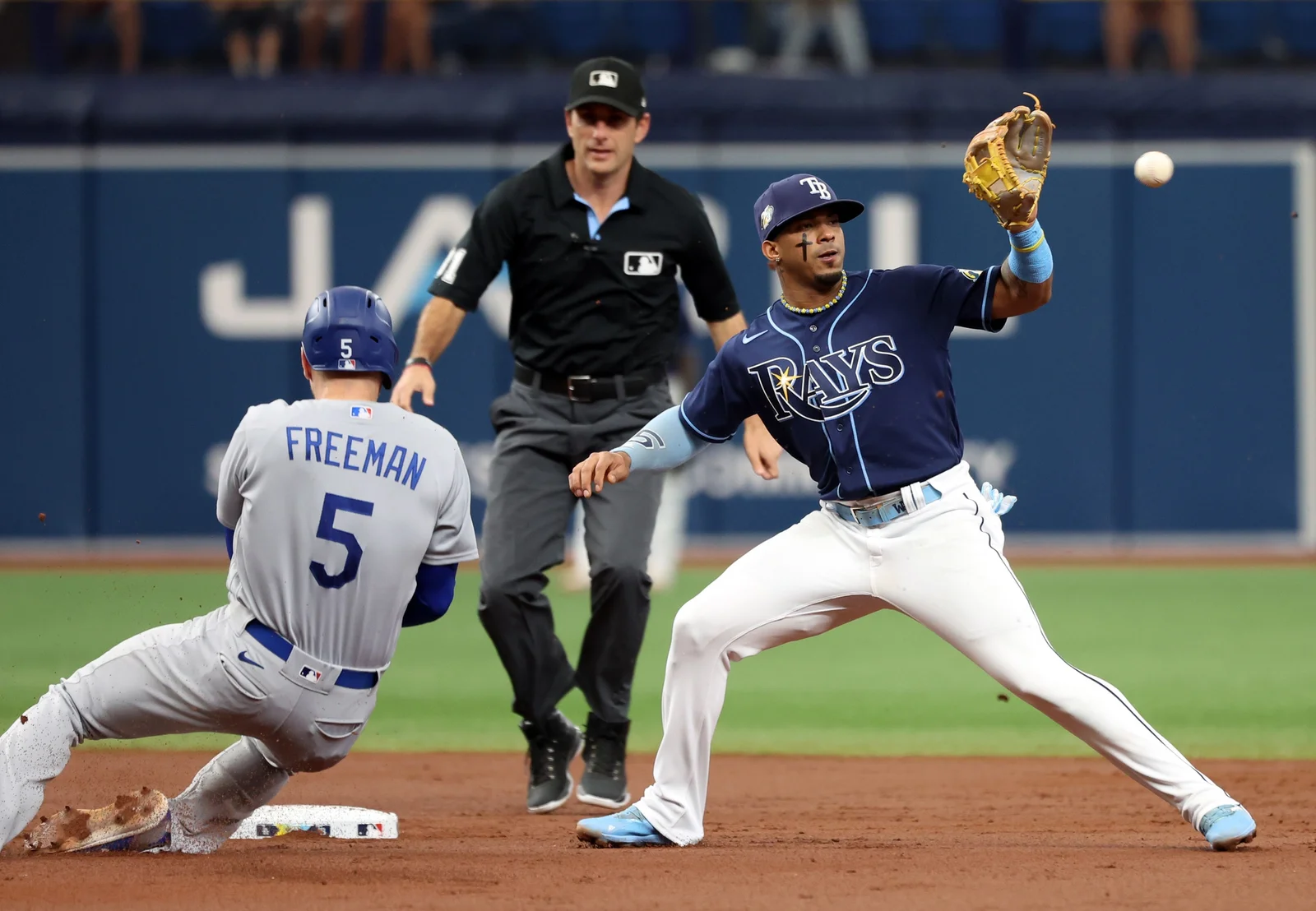 Rays edge out Dodgers in high-scoring game with Paredes homer.