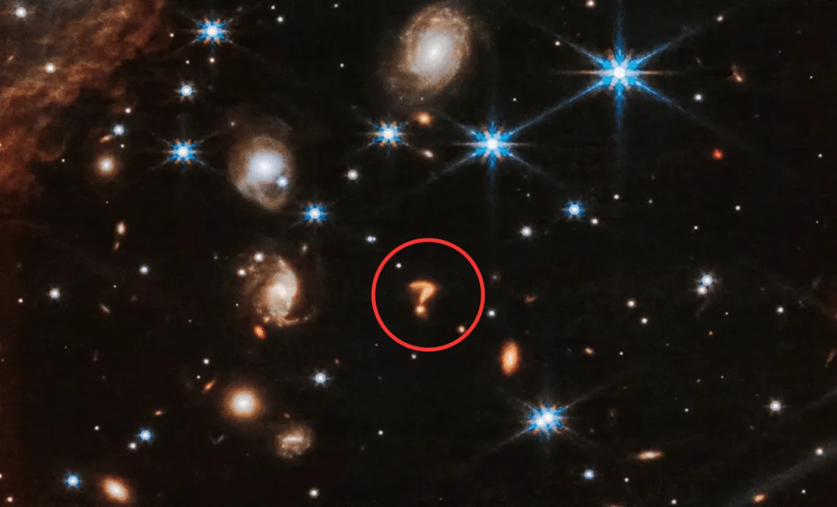 Webb Telescope Captures a Cosmic Question Mark in a Distant Galaxy