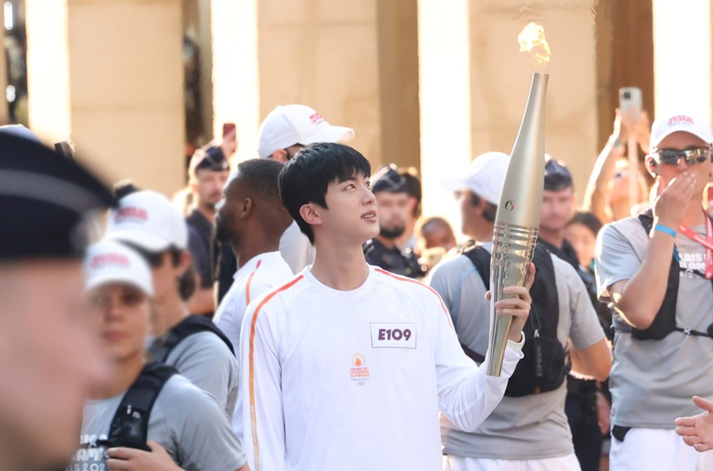 Featured image for "Famous Musicians Who've Carried the Olympic Torch"