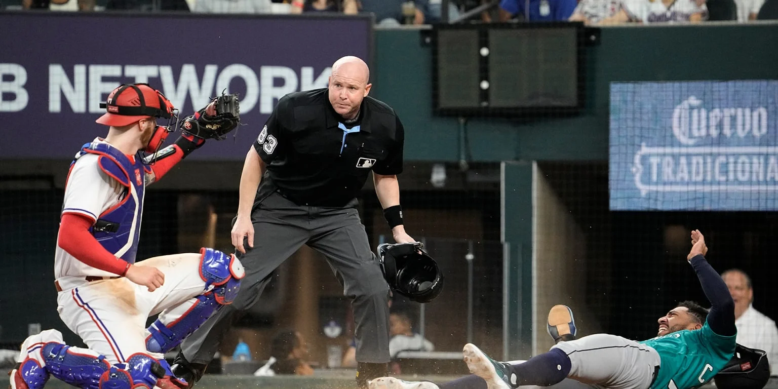 Rangers defeat Mariners with catcher's game-saving tag.
