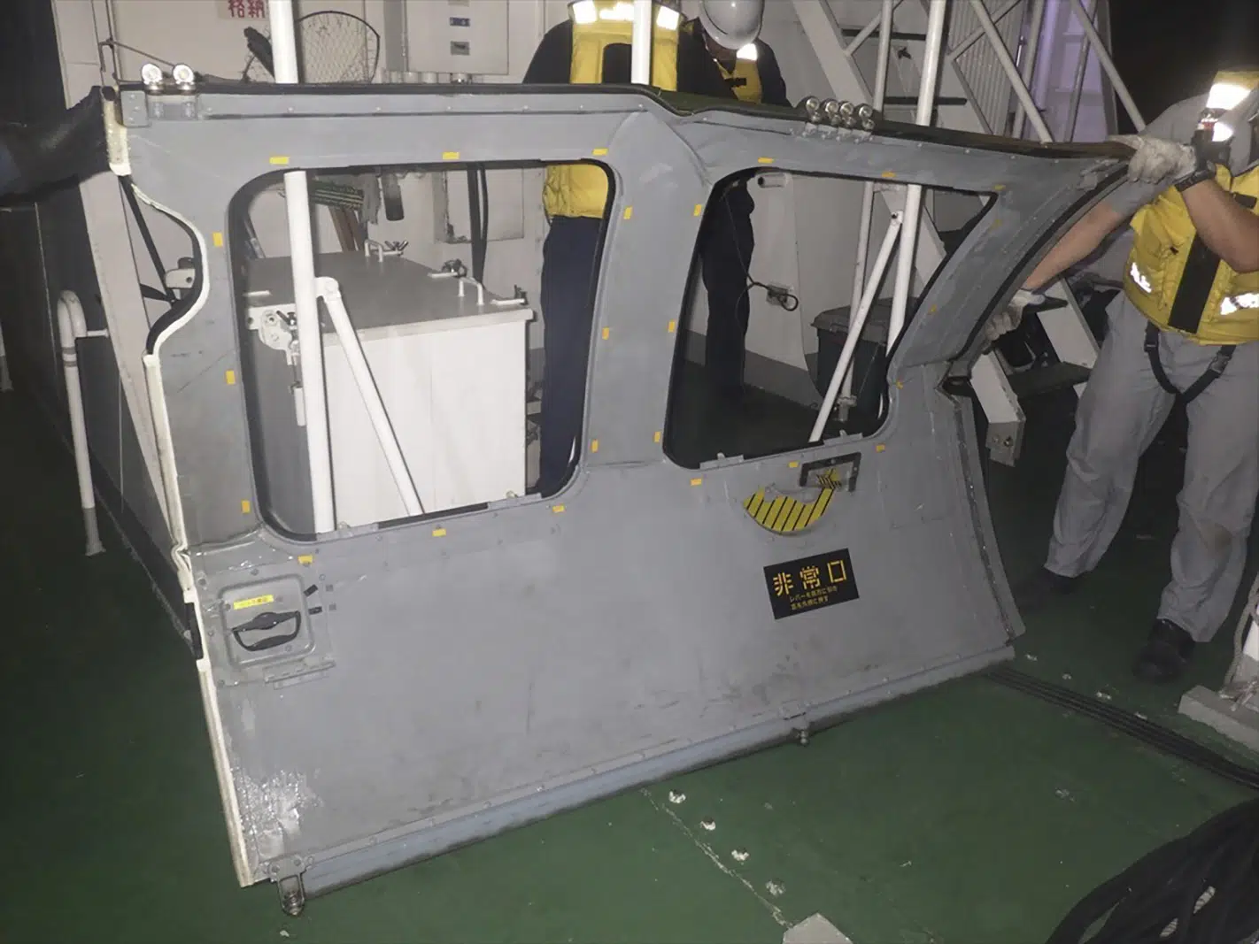 Debris recovered as search for missing Japanese military helicopter crew continues.