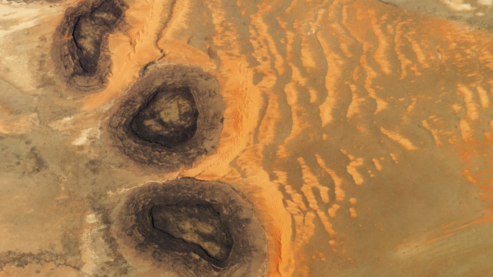 Featured image for Paleozoic 'Black Mesas' Create Rare Sahara Sand Dunes from Space