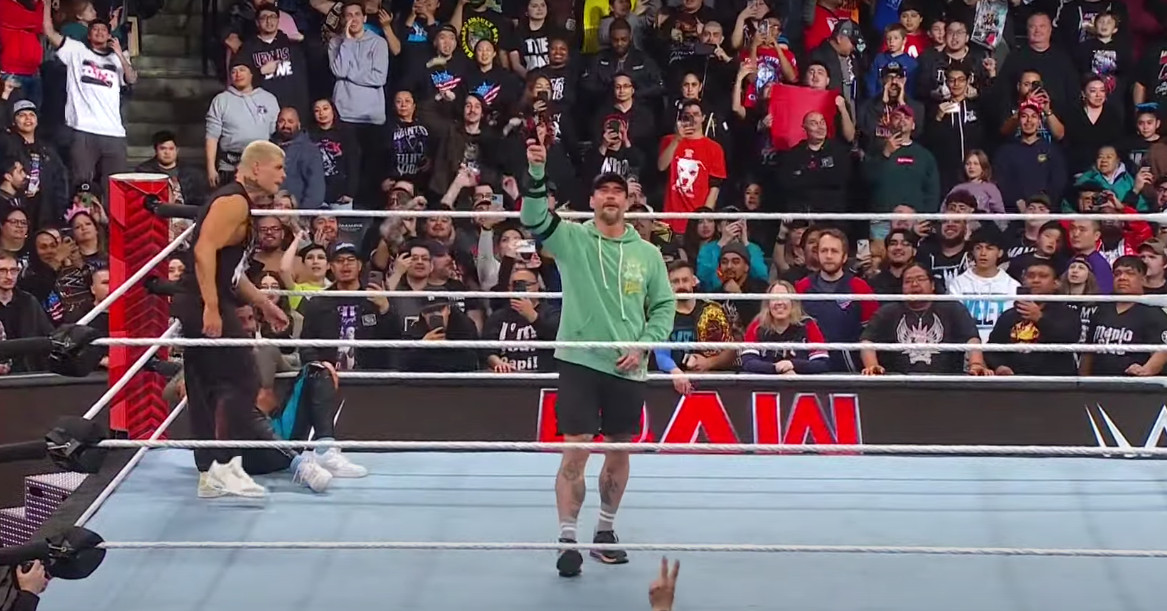 "CM Punk's Surprise Appearance and WrestleMania Main Event Revelation"