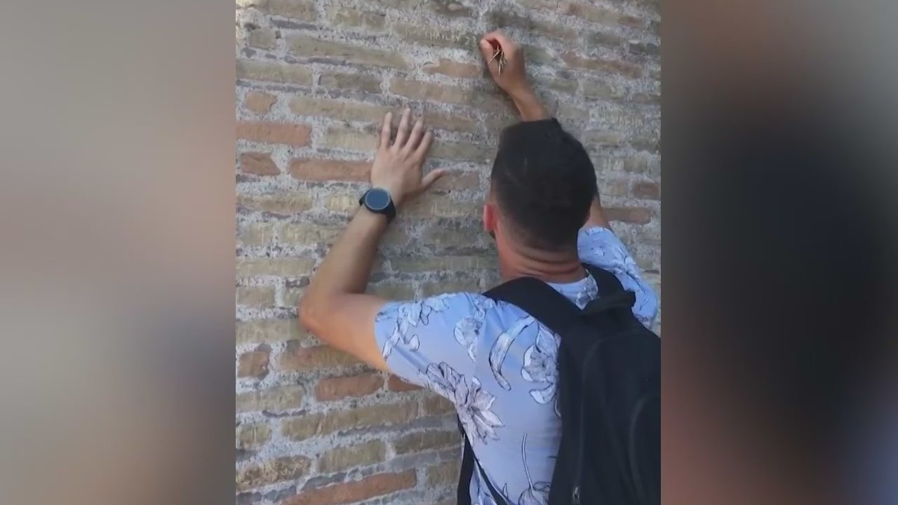 Tourist caught on camera vandalizing Rome's Colosseum with love note carving.