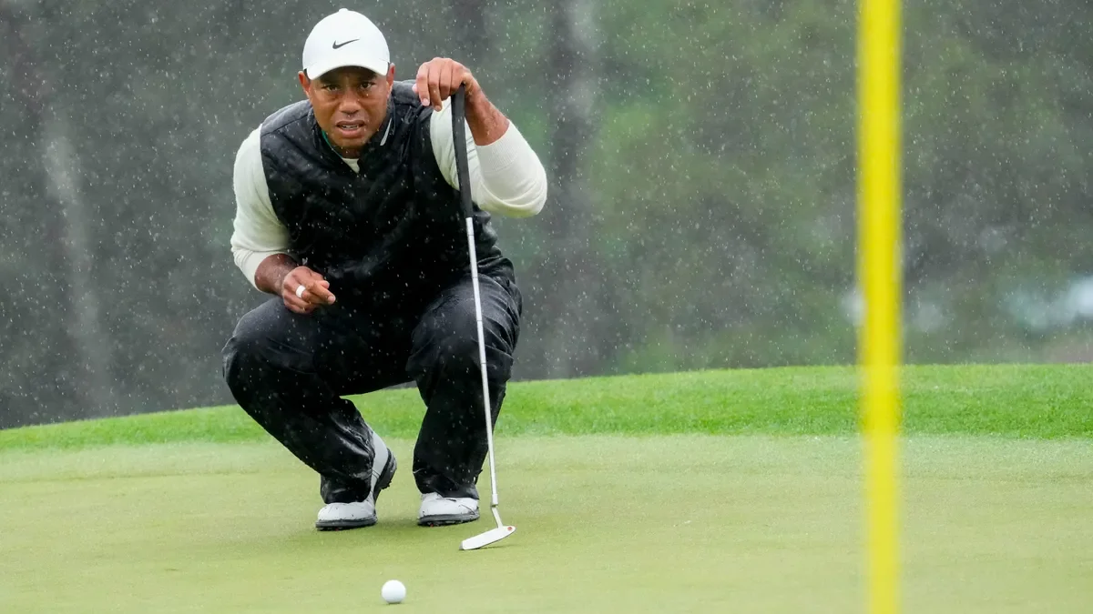 "Tiger Woods survives stormy Masters weekend, secures spot in cut."