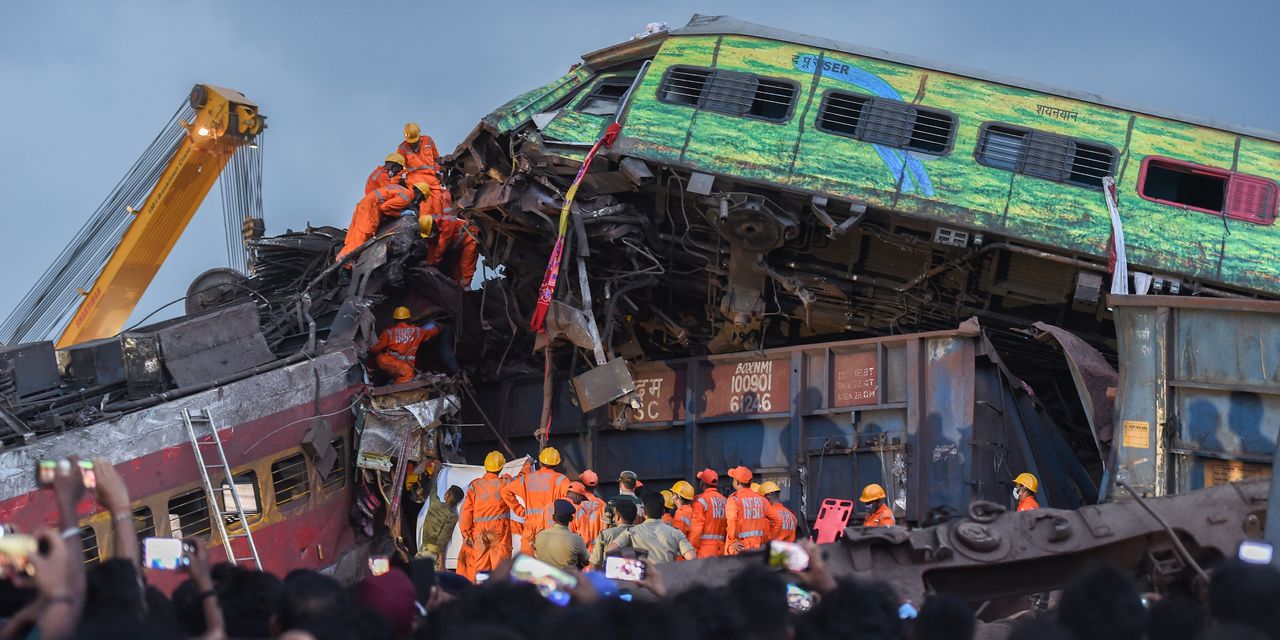 India's Deadly Train Disaster: Rescuers Search Filled Railcars for Victims.