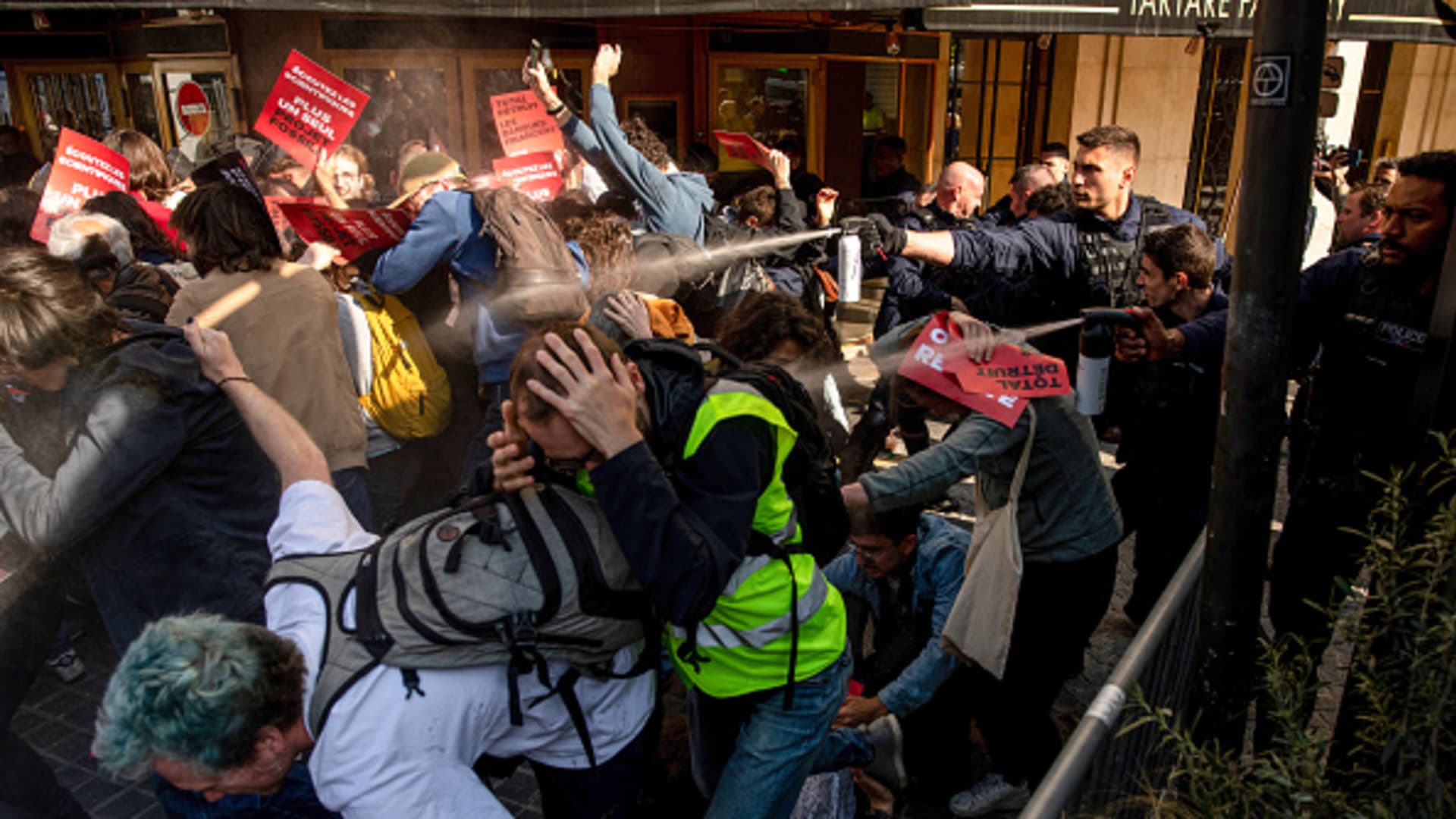 Featured image for Police use tear gas on climate protesters at TotalEnergies shareholder meeting in Paris.