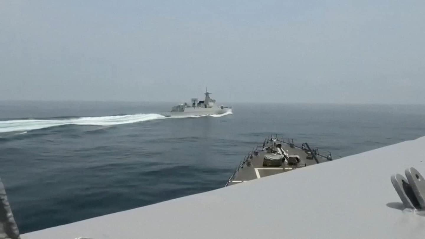 Tensions rise as US and Chinese warships narrowly avoid collision.