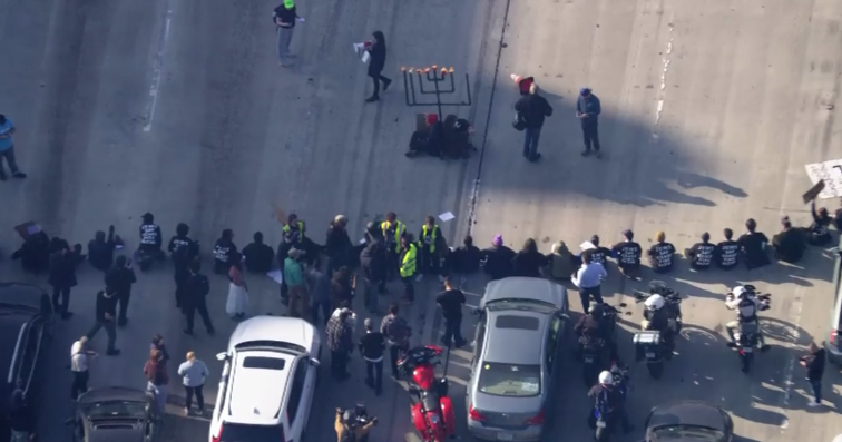 Featured image for Protesters disrupt traffic on 110 Freeway in downtown LA
