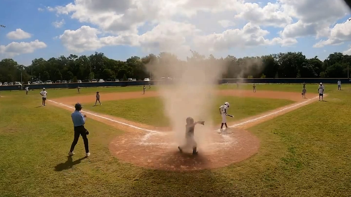 Featured image for Umpire saves 7-year-old from dust devil during Florida baseball game.
