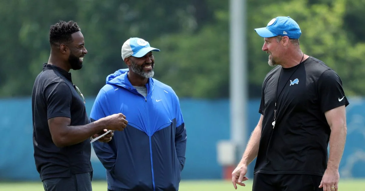 Calvin Johnson offers support to Jameson Williams at Detroit Lions minicamp.