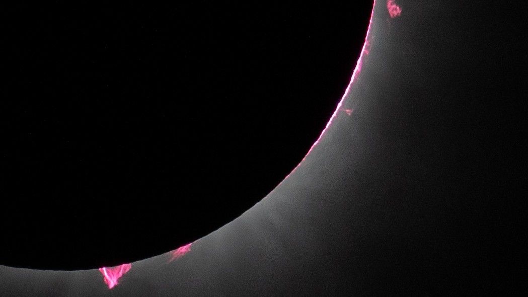 Featured image for "Unveiling the Mystery: NASA's Discovery of Enormous Pink 'Flames' During Total Solar Eclipse"